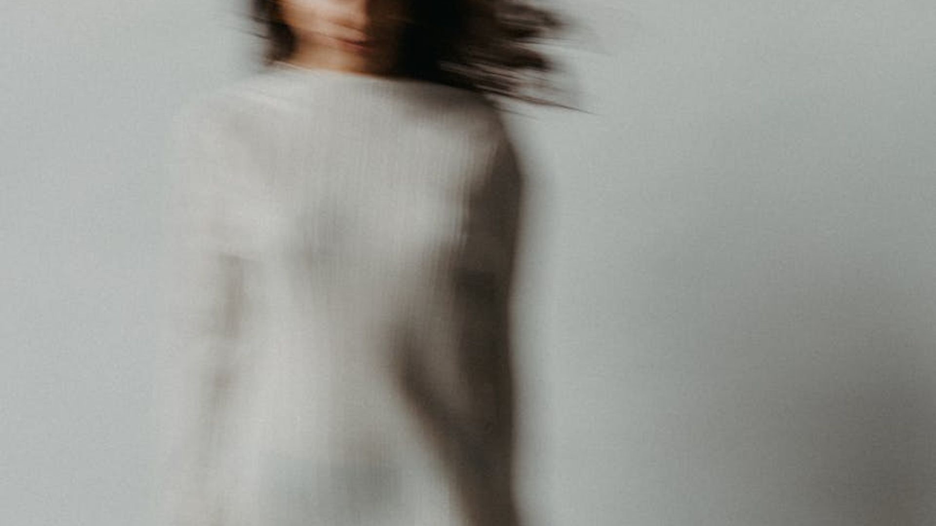 Abstract background with soft, flowing lines suggesting movement.