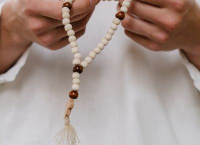 Close-up of hands in a meditative gesture.